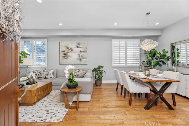 a dining room with furniture window and wooden floor