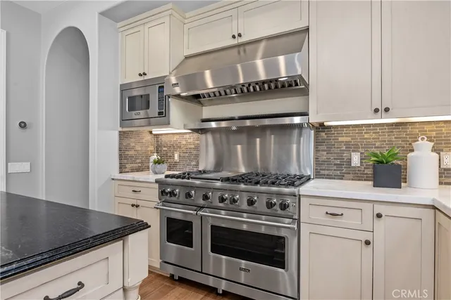 a kitchen with stainless steel appliances granite countertop a stove and a sink