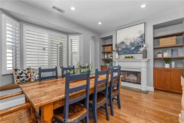 a dining room with furniture window and wooden floor