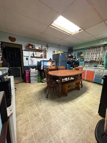 a bed room with a bed and a view of kitchen