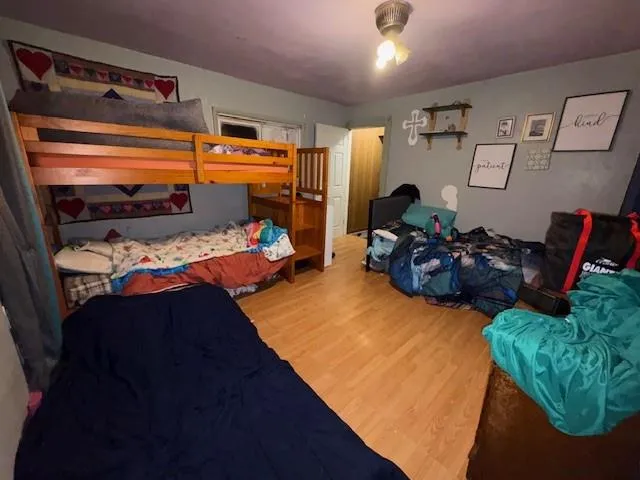 a bed room with a bed a chair and a chandelier