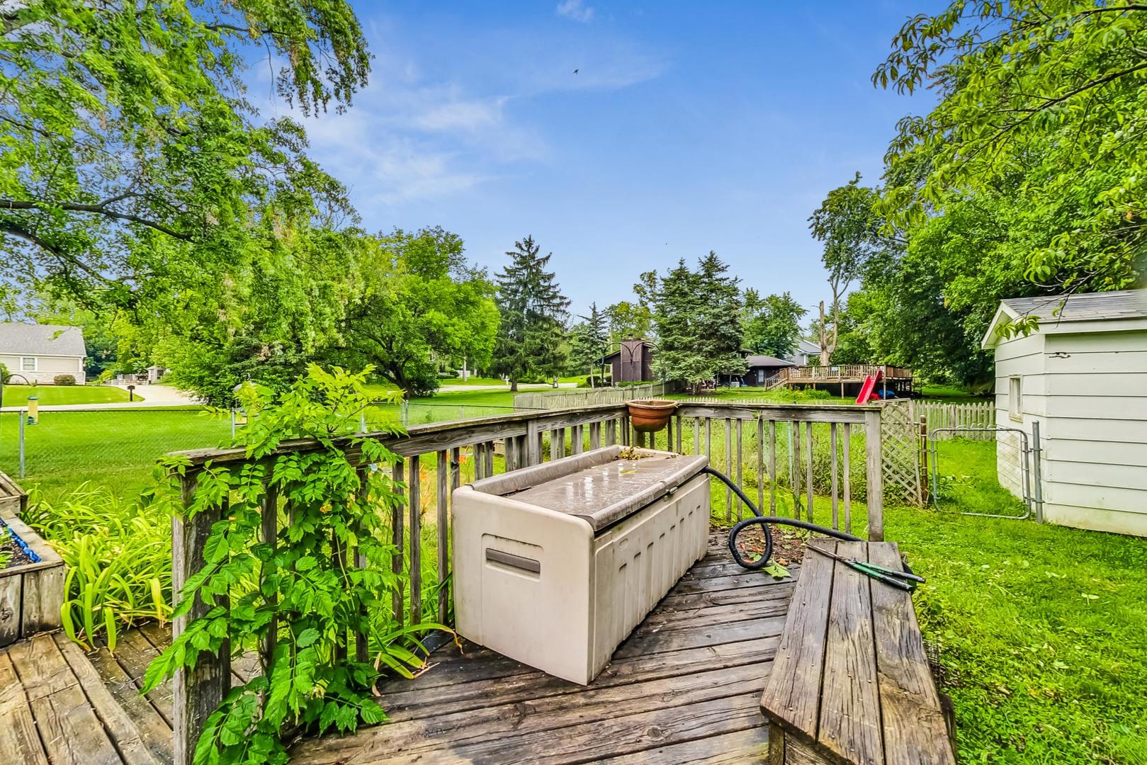 5701 Lenox Road Lisle, IL 60532 - Photo 21 of 24 a view of a wooden deck with a yard