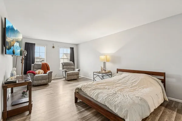 a bedroom with double bed and a couch