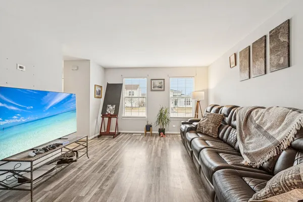 a living room with furniture window and wooden floor