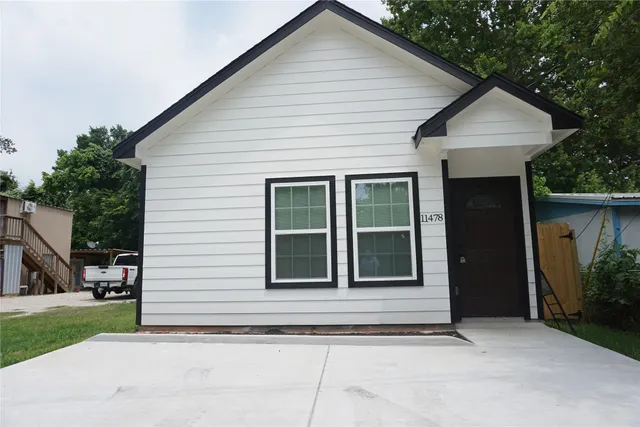 a view of a house with a garden and pathway