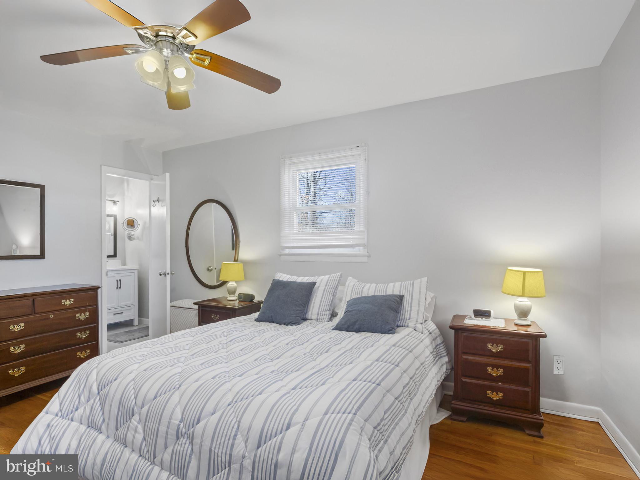 935 Loxford Terrace Silver Spring, MD 20901 - Photo 14 of 42 a bedroom with a bed and wooden floor