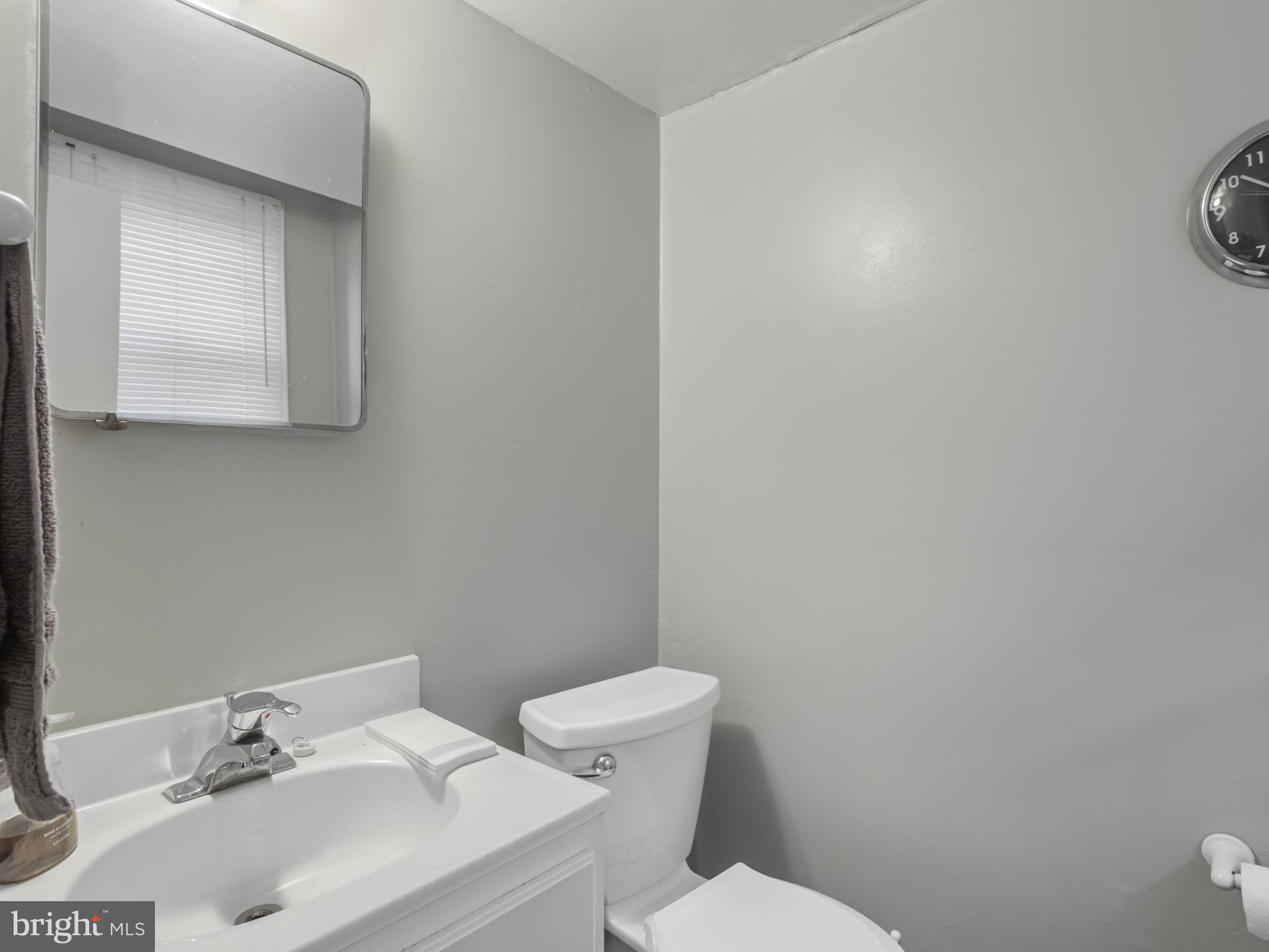 935 Loxford Terrace Silver Spring, MD 20901 - Photo 32 of 42 a bathroom with a sink mirror and toilet
