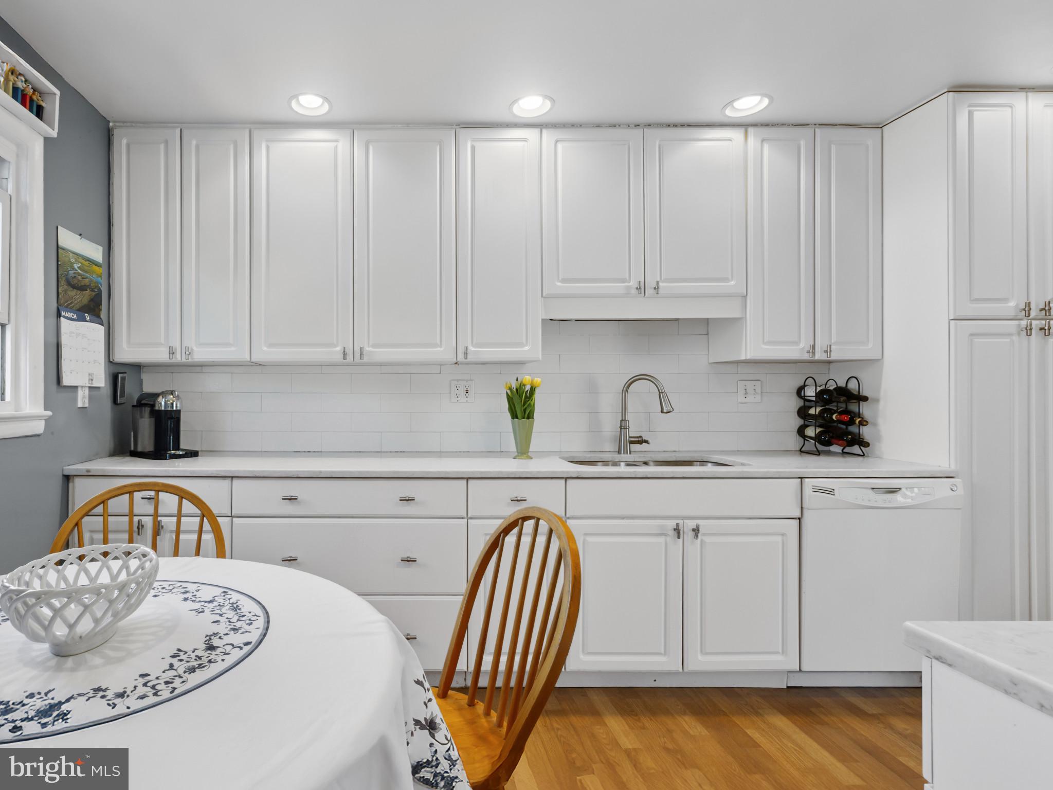 935 Loxford Terrace Silver Spring, MD 20901 - Photo 8 of 42 a kitchen with a sink white cabinets and black appliances