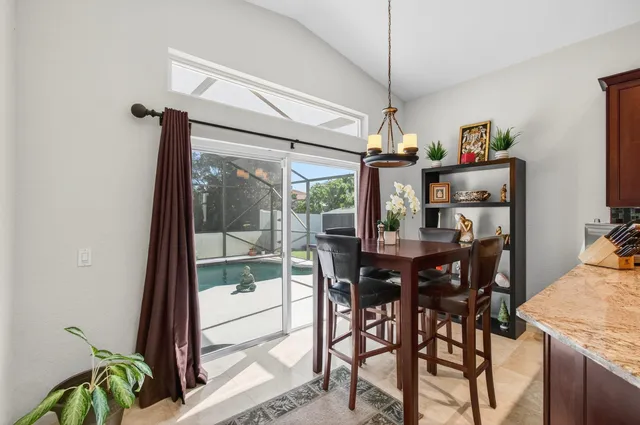 a living room with furniture a flat screen tv and kitchen view