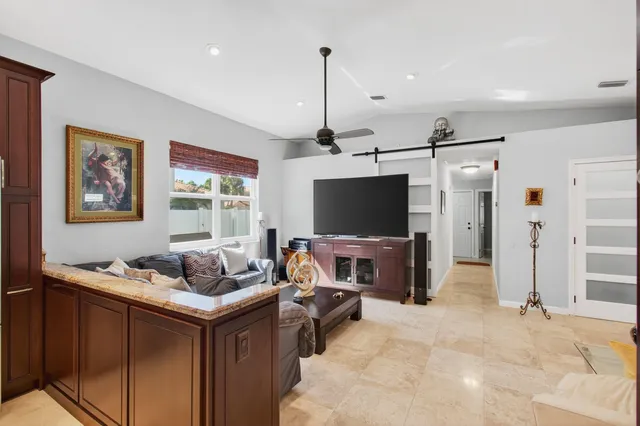 a living room with furniture and a lamp