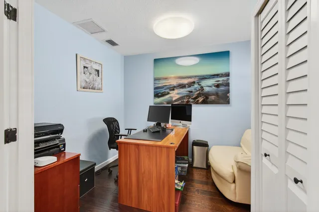 a bedroom with a bed and a ceiling fan