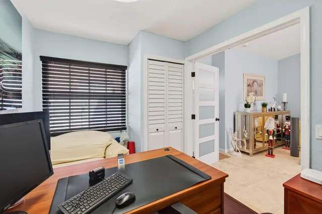 a bedroom with a bed and a large window