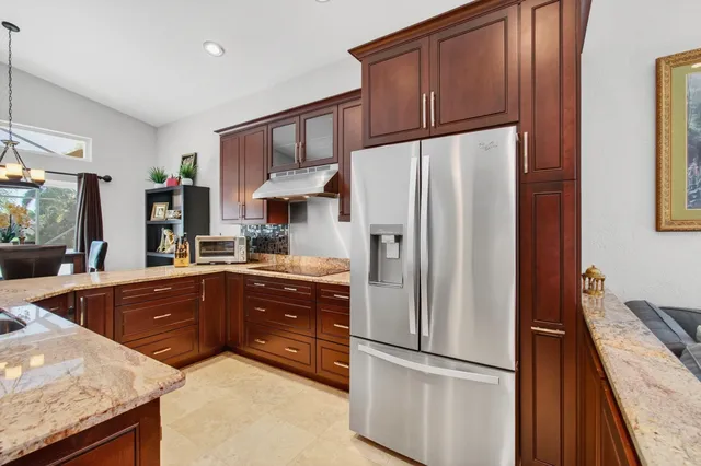 a bathroom with a granite countertop sink a toilet and shower