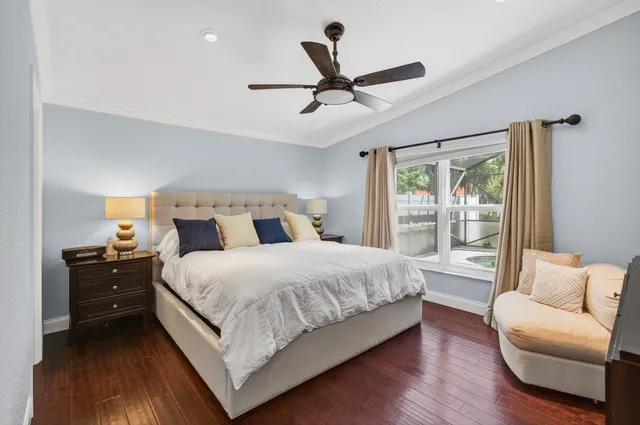 a bedroom with a bed and a wall painting