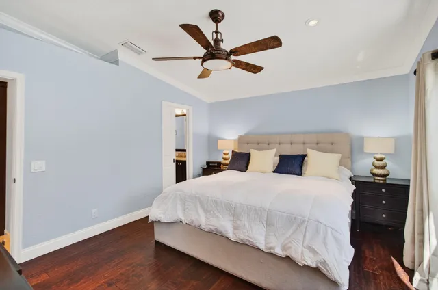 a view of a backyard with a table and chairs under an umbrella