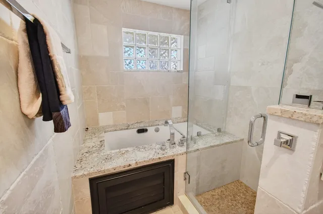 a view of a backyard with plants and a bench