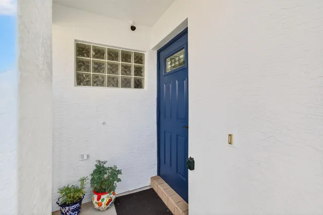 a living room with furniture a large window and a chandelier