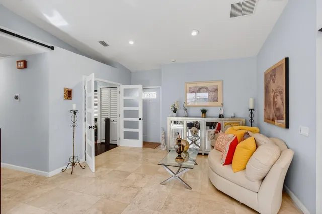 a kitchen with granite countertop a refrigerator a stove a sink dishwasher and a refrigerator with wooden floor