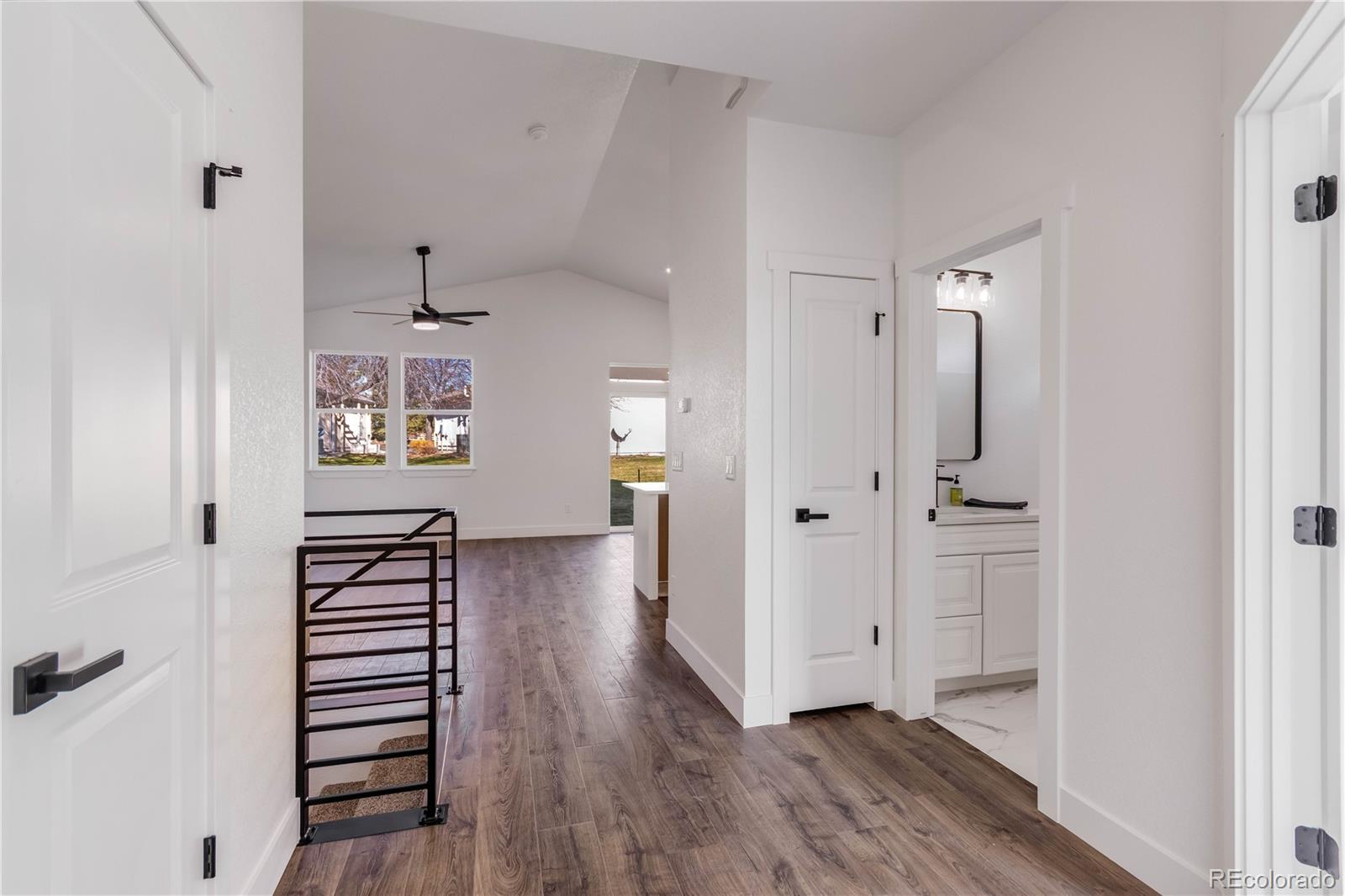 1230 Swainson Road Eaton, CO 80615 - Photo 2 of 35 a view of a hallway with wooden floor and closet
