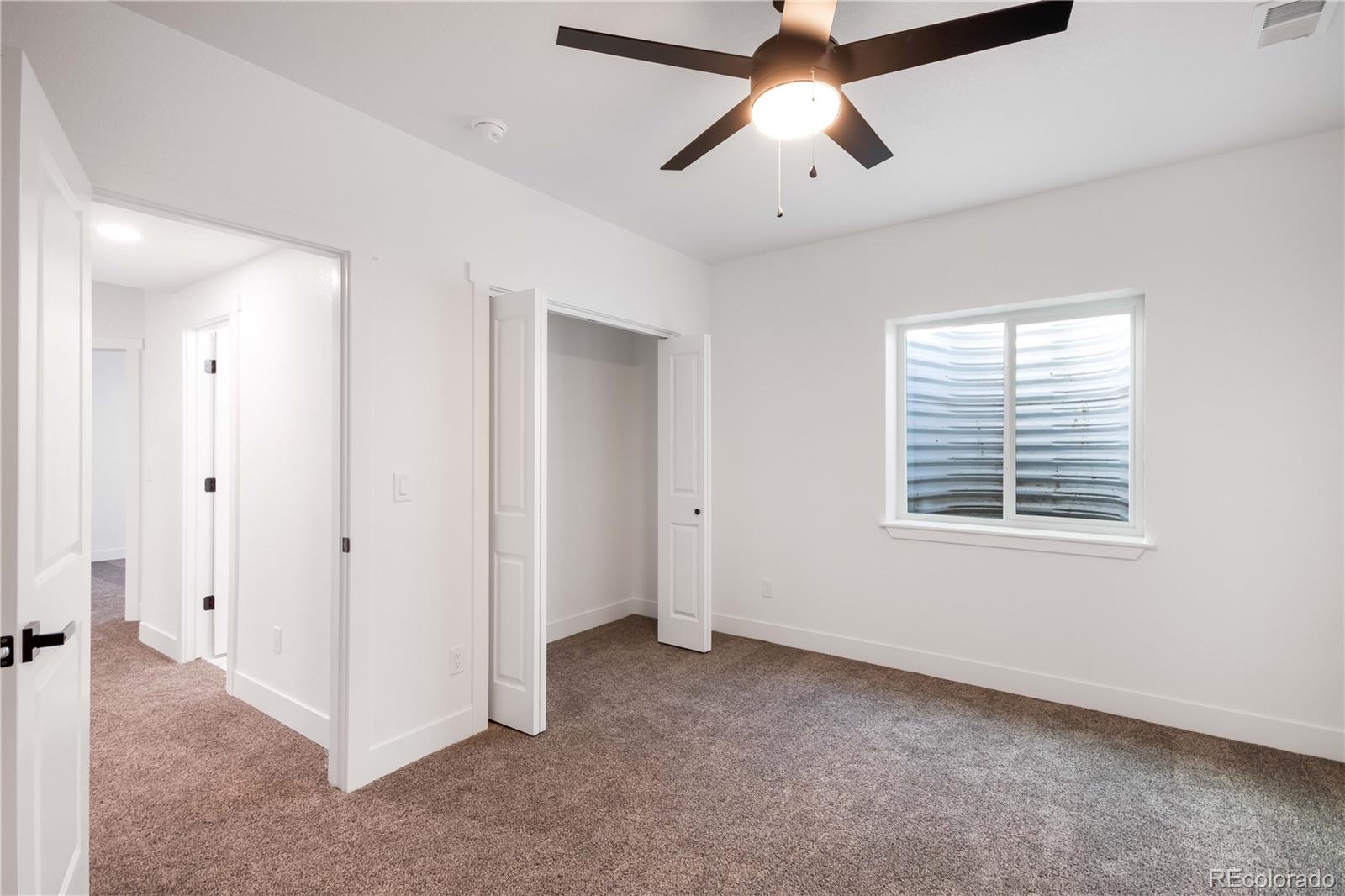 1230 Swainson Road Eaton, CO 80615 - Photo 31 of 35 a view of a room with a ceiling fan and a window
