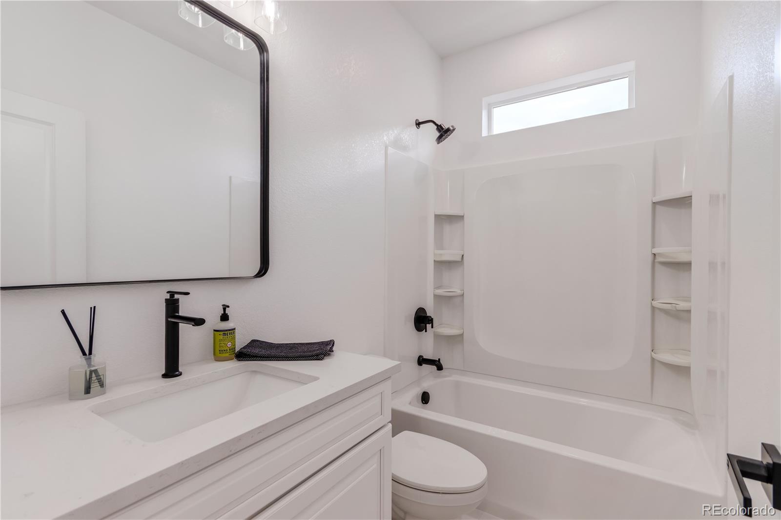 1230 Swainson Road Eaton, CO 80615 - Photo 4 of 35 a bathroom with a bathtub sink vanity and toilet