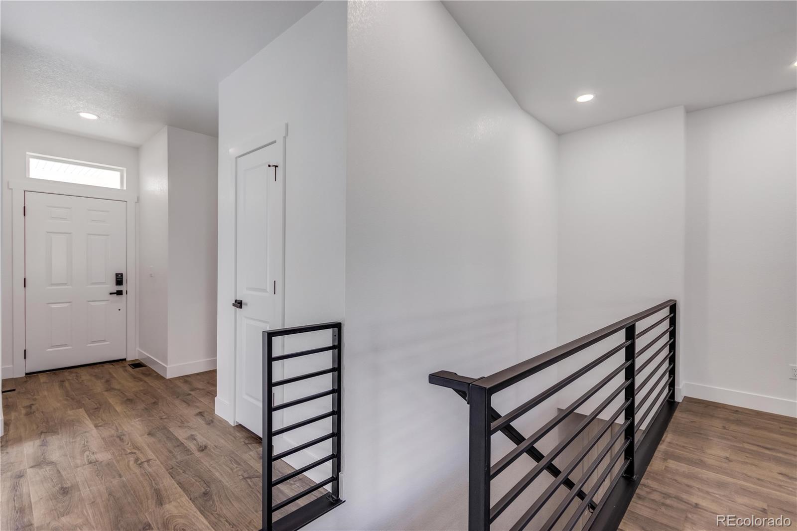1230 Swainson Road Eaton, CO 80615 - Photo 5 of 35 a view of a hallway with wooden floor and closet