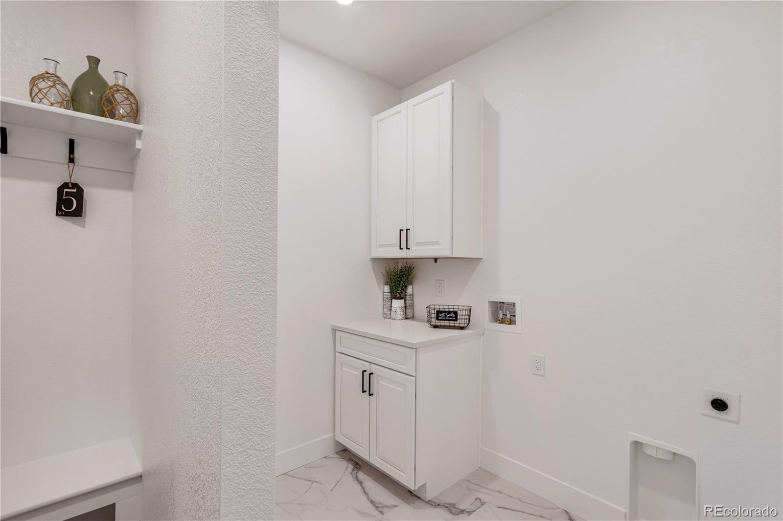1230 Swainson Road Eaton, CO 80615 - Photo 7 of 35 a kitchen with white cabinets and white appliances
