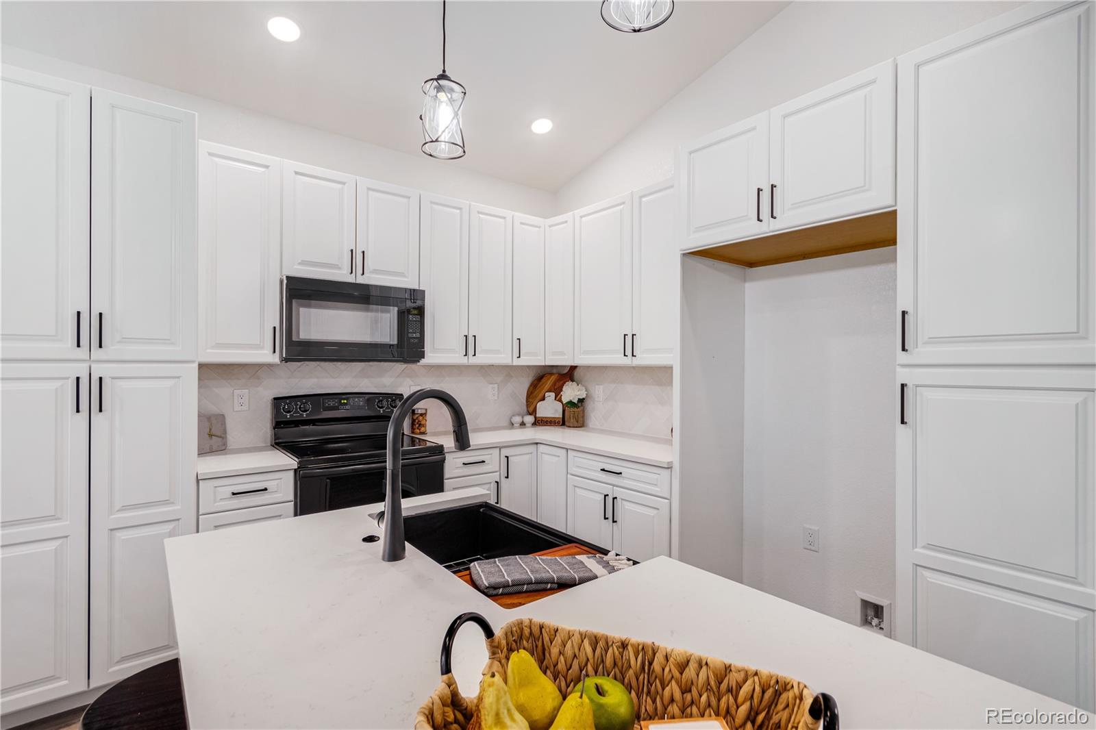 1230 Swainson Road Eaton, CO 80615 - Photo 10 of 35 a kitchen with a refrigerator and a stove top oven