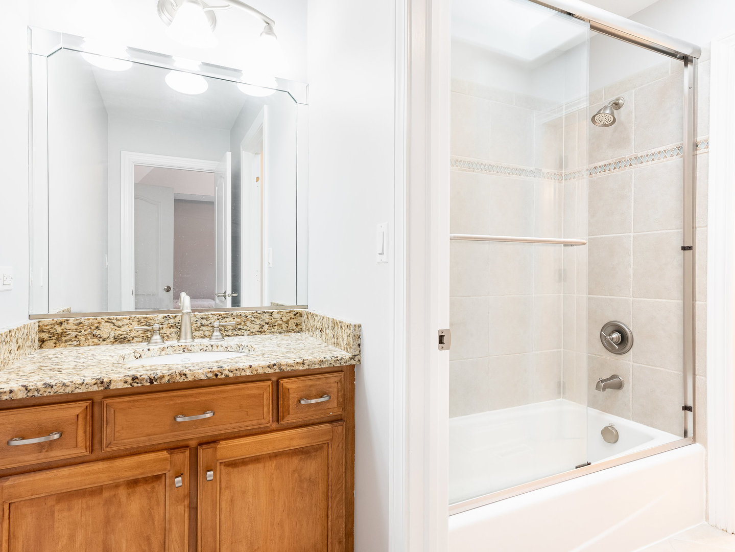 2223 Spartina Lane Naperville, IL 60564 - Photo 31 of 48 a bathroom with a granite countertop sink mirror and a bath tub