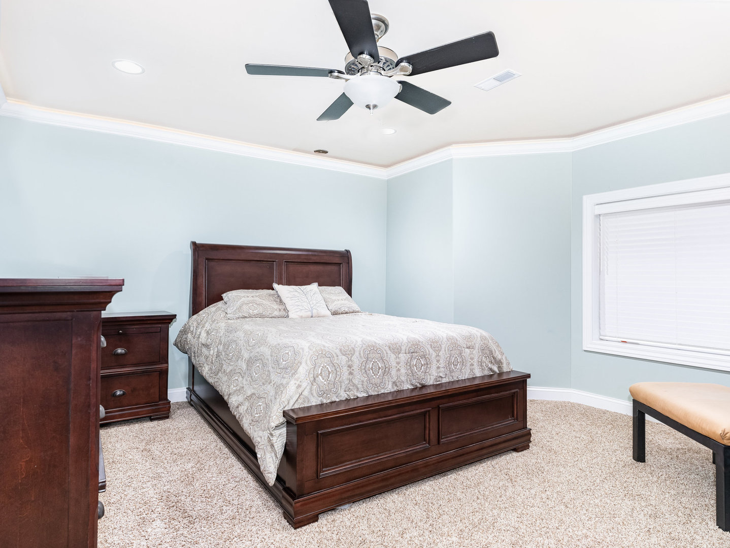 2223 Spartina Lane Naperville, IL 60564 - Photo 39 of 48 a bed sitting in a bedroom next to a window with a chandelier