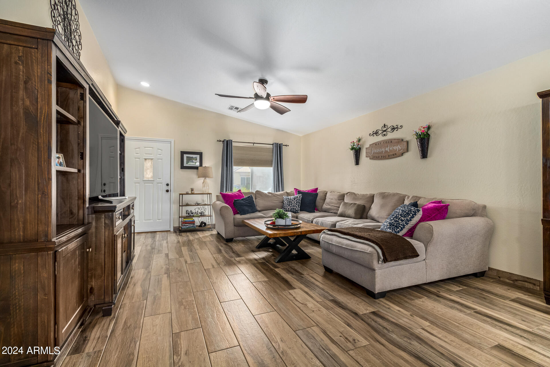 9208 West Payson Road Tolleson, AZ 85353 - Photo 2 of 23 a living room with furniture and a wooden floor