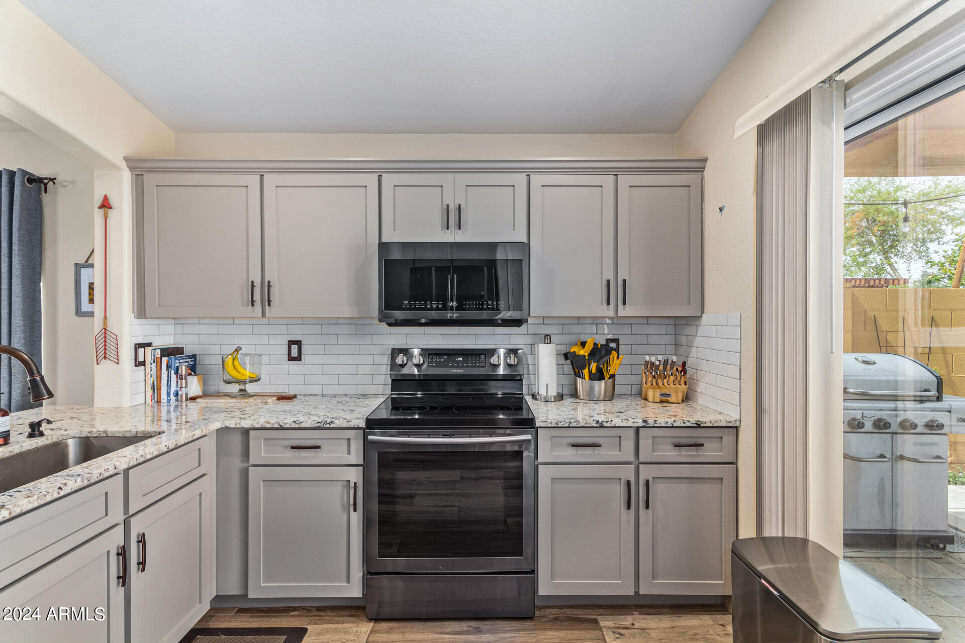 9208 West Payson Road Tolleson, AZ 85353 - Photo 8 of 23 a kitchen with stainless steel appliances white cabinets and a sink