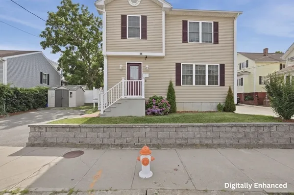 a view of a house with a yard and a garage