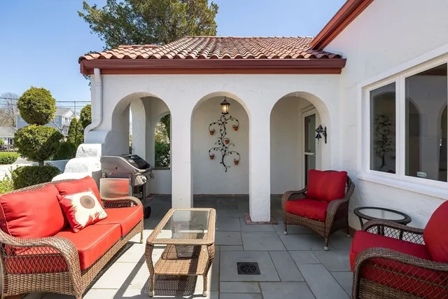 a front view of a house with outdoor seating