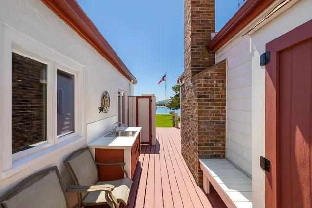a balcony with furniture and wooden floor