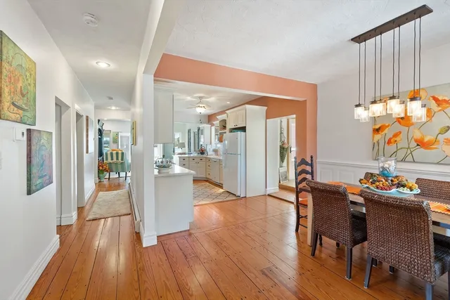 a dining room with furniture and a wooden floor