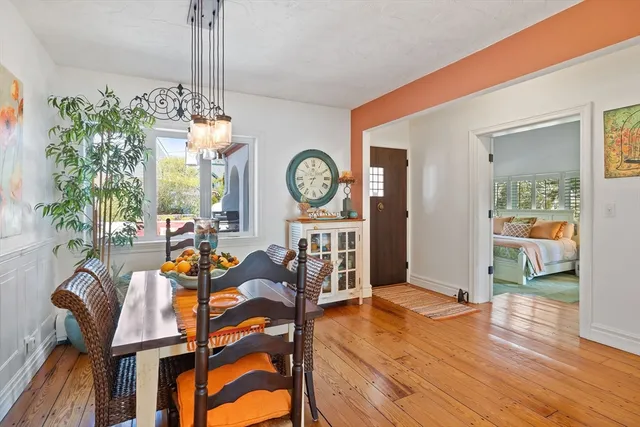 a view of a dining room with furniture and a chandelier