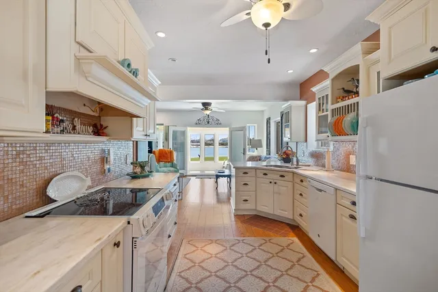 a kitchen with furniture a sink stainless steel appliances and cabinets