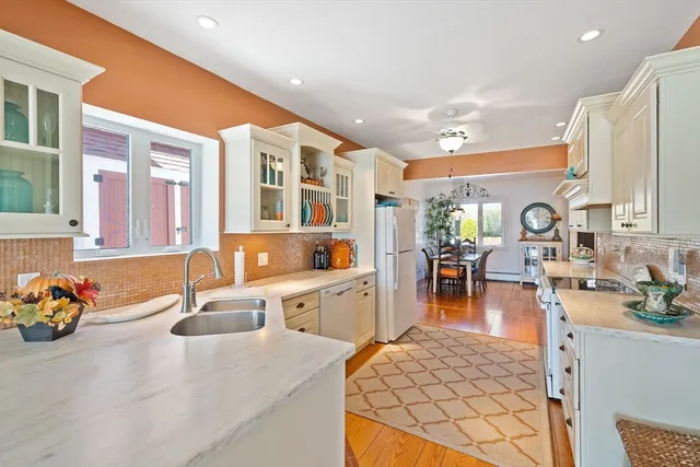 a kitchen with sink refrigerator and dining table