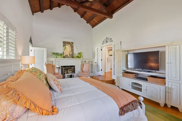 a bedroom with a bed and a flat screen tv