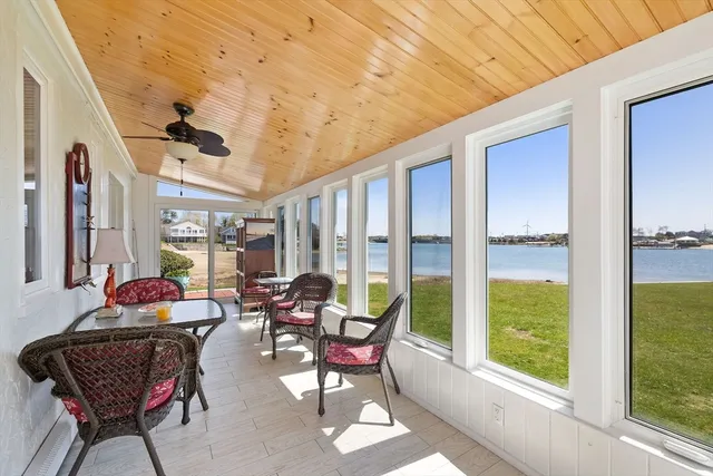 a living room with furniture and floor to ceiling windows