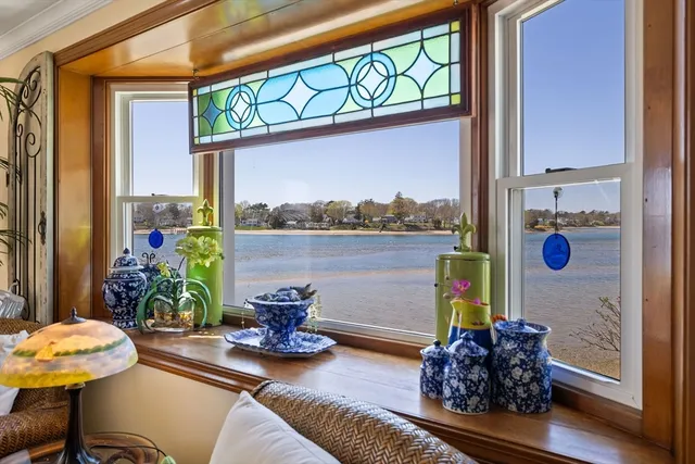 a living room filled with furniture and a potted plant