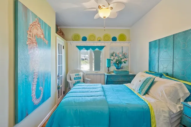 a bedroom with bed and a chandelier