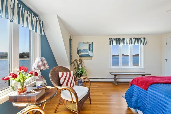 a bedroom with furniture and a potted plant
