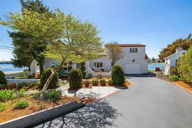 a view of a house with backyard and sitting area