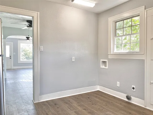 an empty room with windows and wooden door
