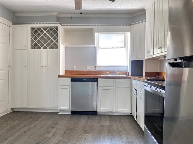 a kitchen with granite countertop white cabinets and white appliances