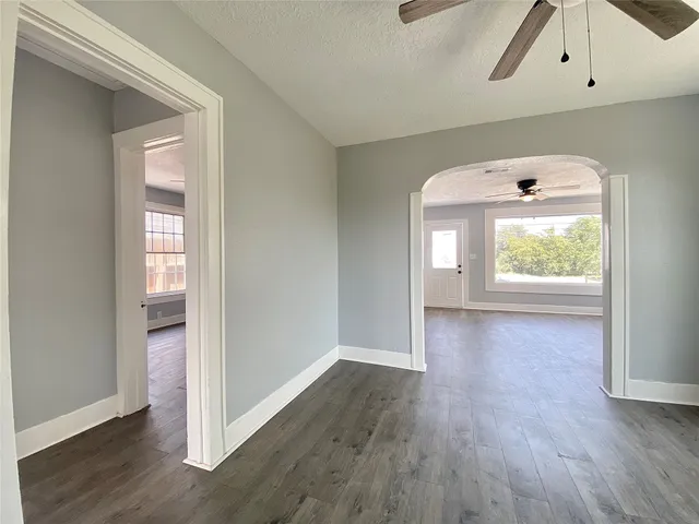 an empty room with wooden floor and a window