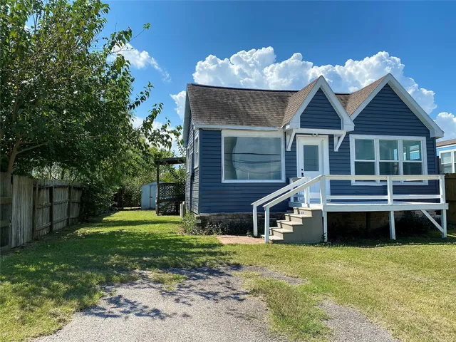 a front view of a house with a yard table and chairs