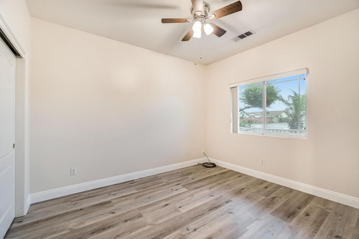 2095 Independence Place Hanford, CA 93230 - Photo 11 of 35 an empty room with a window and a ceiling fan